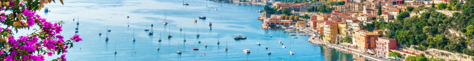 A picturesque coastal view with colorful buildings and boats in a serene harbor | MSC Cruises A picturesque coastal view with colorful buildings and boats in a serene harbor | MSC Cruises