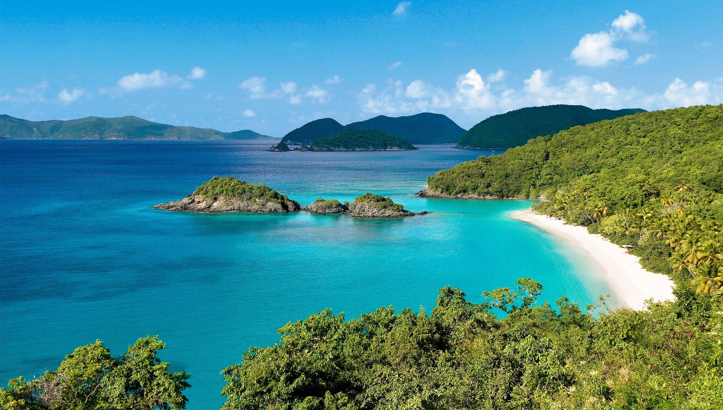 A secluded tropical beach with turquoise waters and lush green hills | MSC Cruises A secluded tropical beach with turquoise waters and lush green hills | MSC Cruises