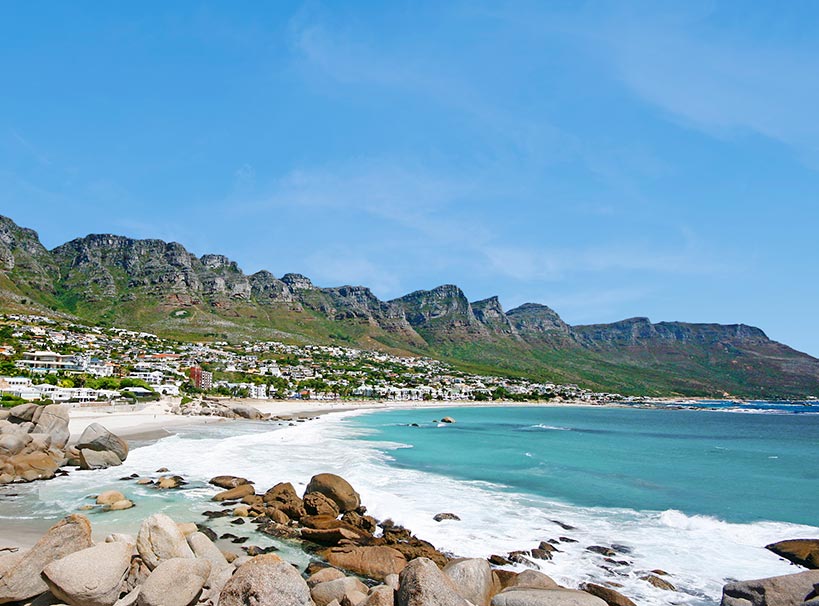 Scenic view of Camps Bay beach with turquoise waters and Twelve Apostles mountain range | MSC Cruises