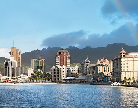 Port Louis waterfront with mountain backdrop and vibrant cityscape | MSC Cruises