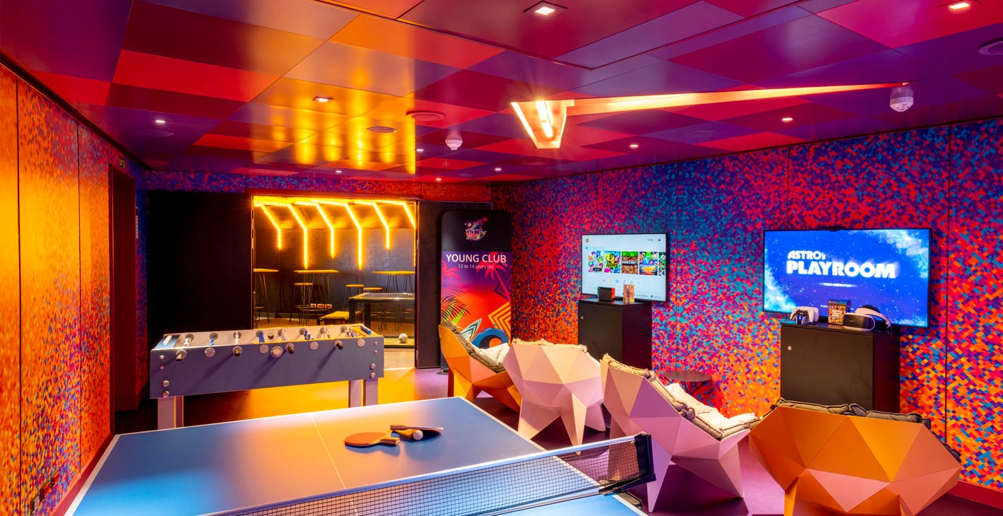 Vibrant onboard youth club with gaming stations, foosball, and table tennis | MSC Cruises