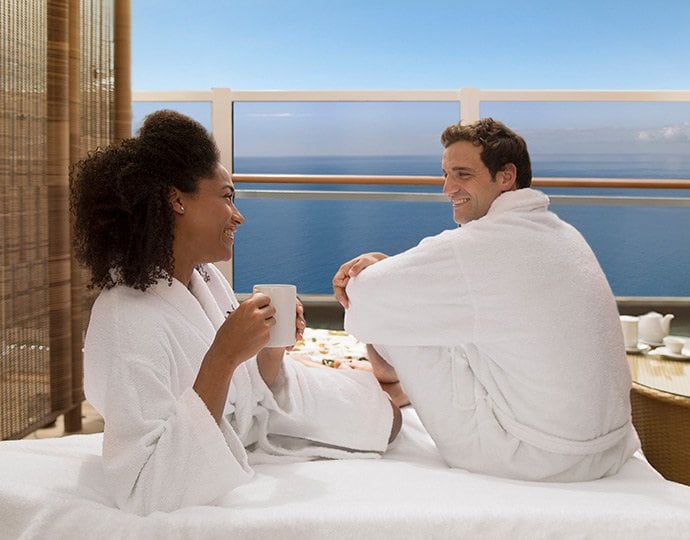 Couple in bathrobes enjoying coffee on a private balcony overlooking the ocean | MSC Cruises Couple in bathrobes enjoying coffee on a private balcony overlooking the ocean | MSC Cruises