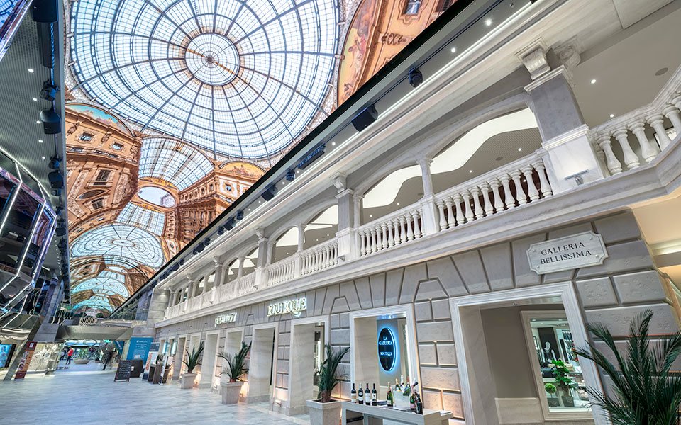 Luxurious shopping promenade with elegant architecture and LED dome ceiling onboard a cruise ship | MSC Cruises