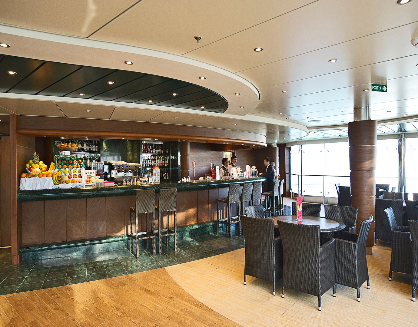 Elegant onboard bar with wicker seating and a variety of fresh fruits and beverages | MSC Cruises Elegant onboard bar with wicker seating and a variety of fresh fruits and beverages | MSC Cruises