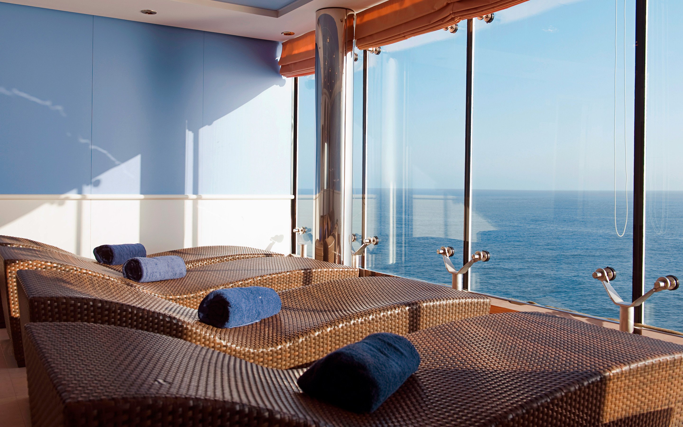 Relaxation area with wicker loungers and ocean views through large windows | MSC Cruises