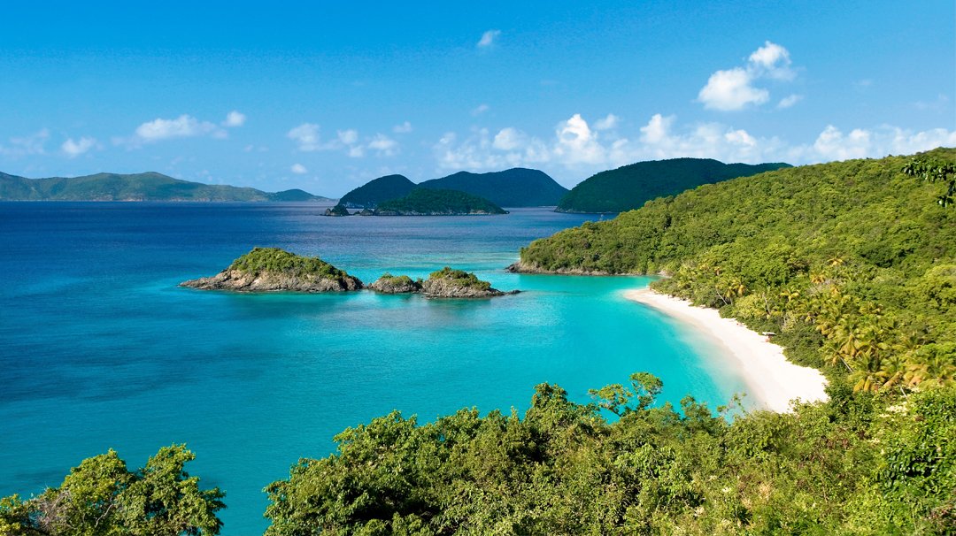 A pristine tropical beach with turquoise waters and lush green hills | MSC Cruises A pristine tropical beach with turquoise waters and lush green hills | MSC Cruises